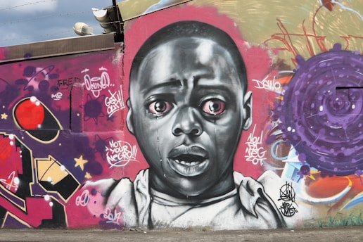 A vibrant mural blending urban graffiti with expressive portraits, capturing raw emotion and street culture.