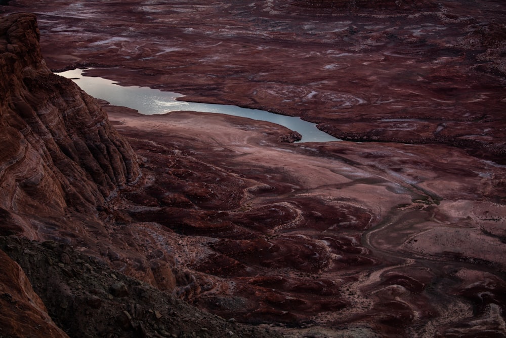 brown field with river at daytime