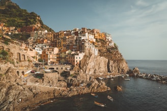The colorful houses of Cinque Terre perched on cliffs overlooking the sparkling Ligurian Sea