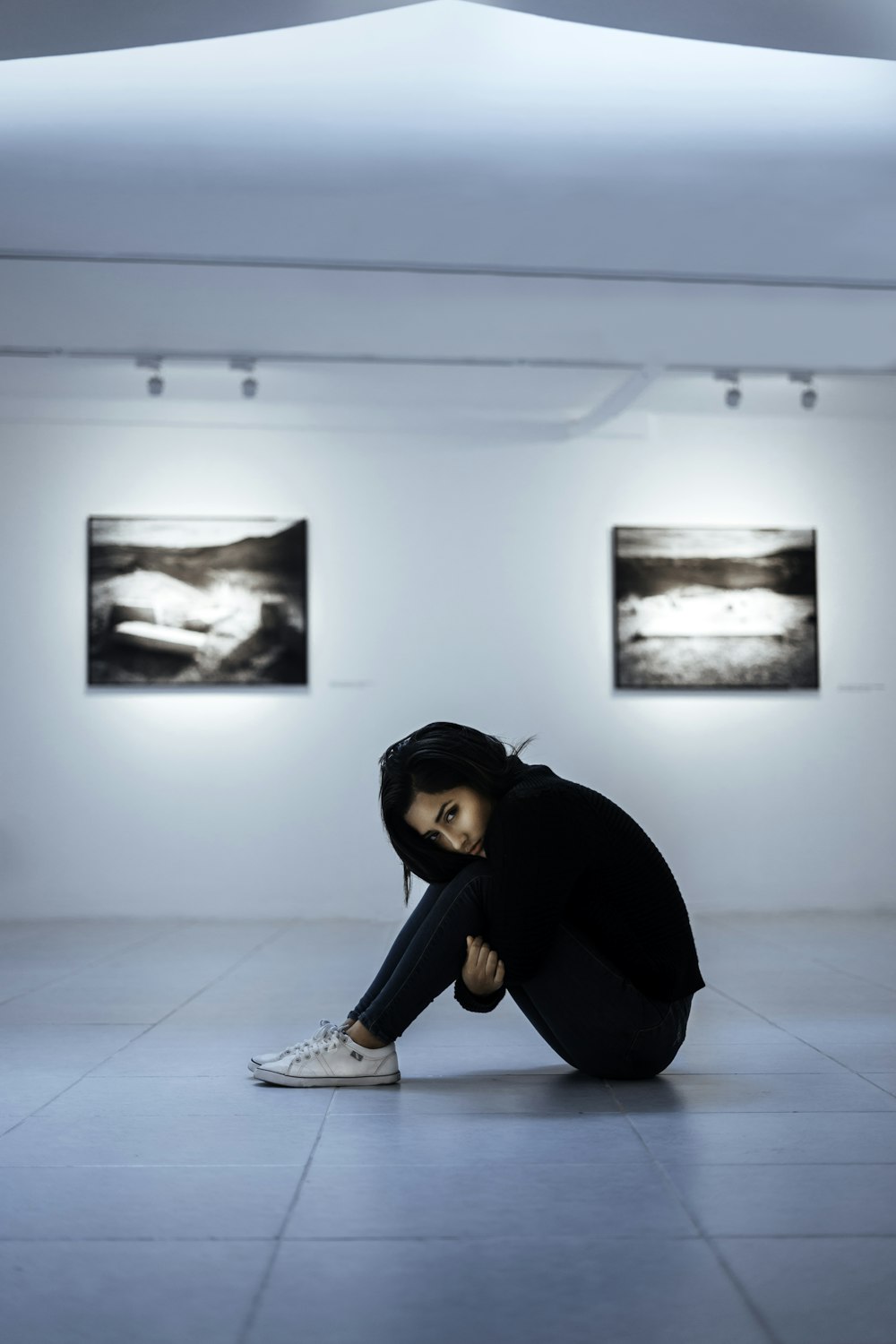 woman sitting on white tiles