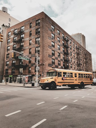 A school bus parked near a school building, where CCSD students who arrive late on the bus can ask the front office for documentation