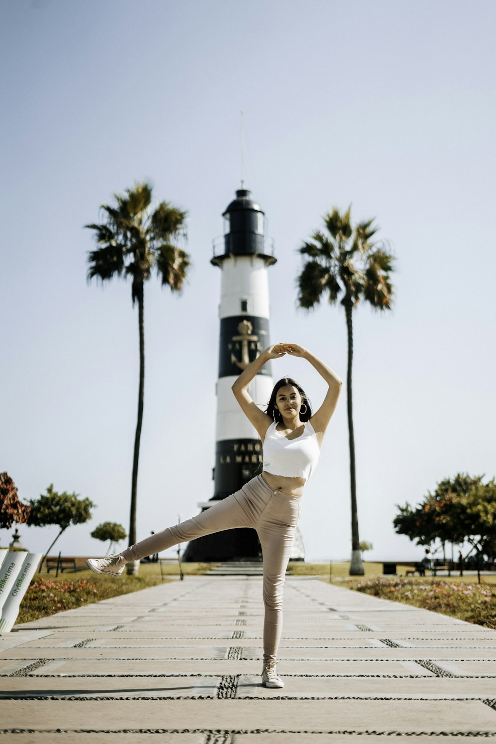 woman standing near lighthouse during daytime