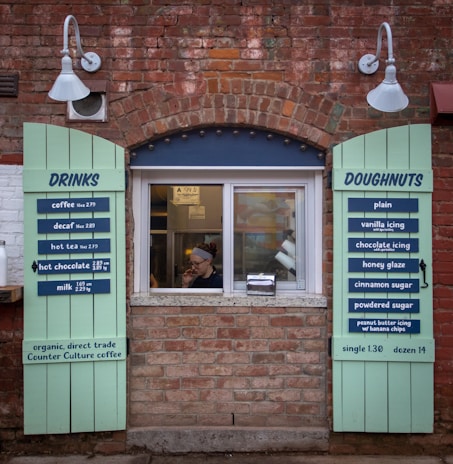 A bustling Dunkin' Donuts storefront owned by Cafua Realty Trust CLXI, with customers enjoying their morning coffee.