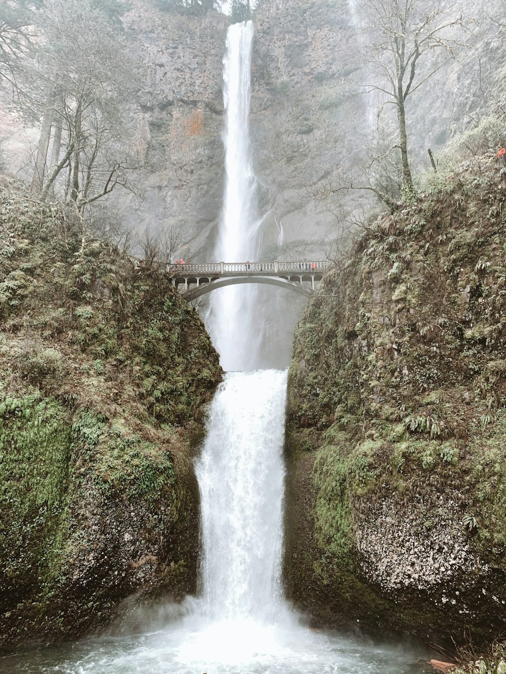 time lapse photography of waterfalls under bridge