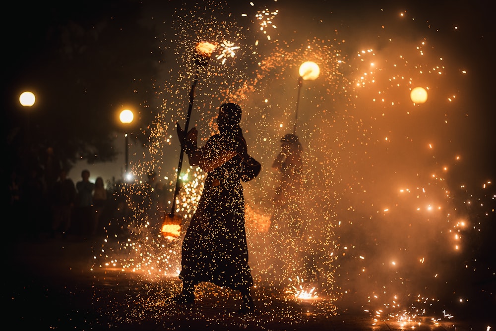 time-lapse photography of fire dancing people