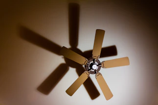 shadow of 5-blade ceiling fan on ceiling