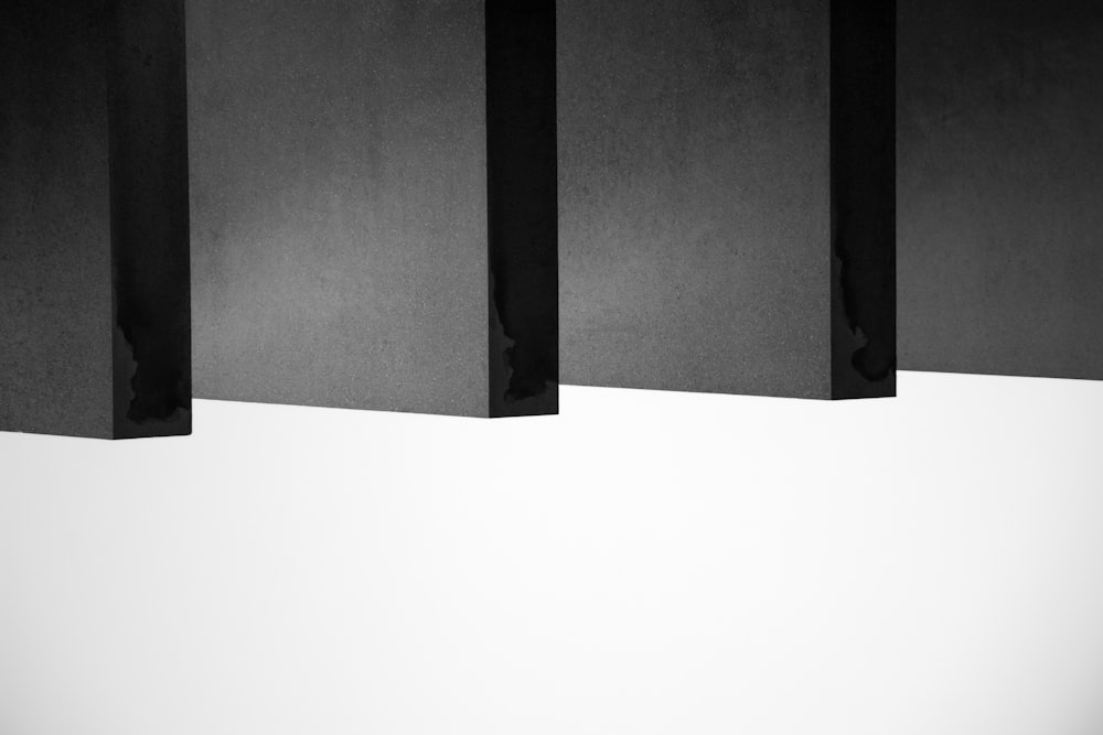 a black and white photo of three black boxes