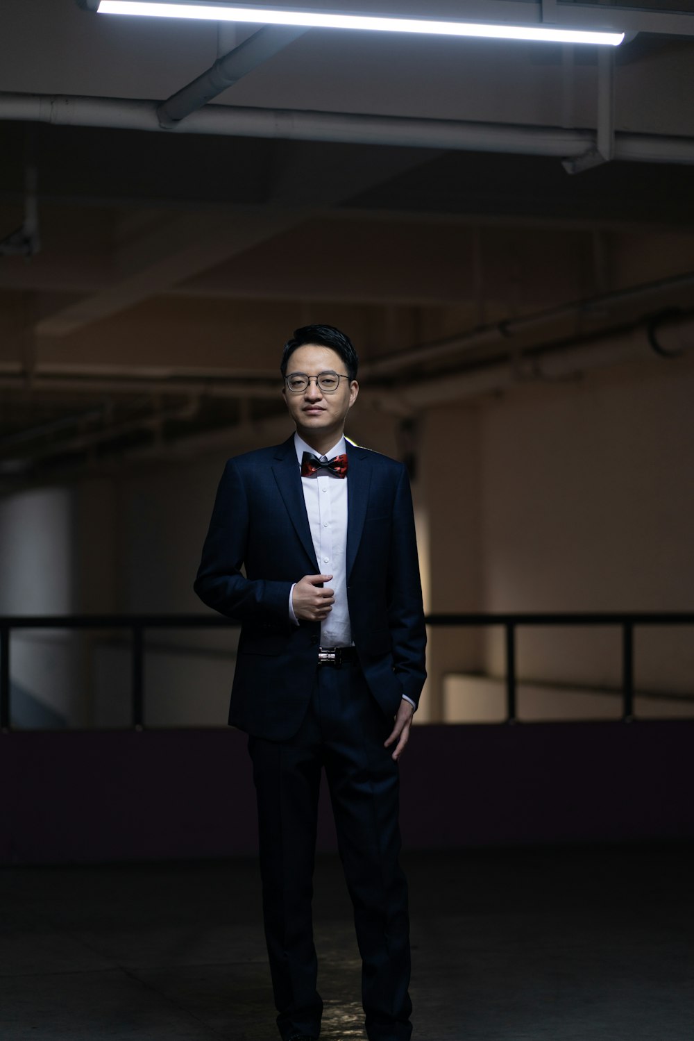 man wearing blue suit in room