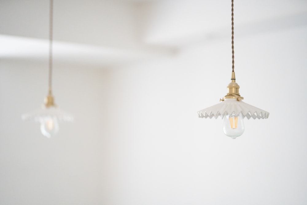 brass-colored clear glass pendant lamp