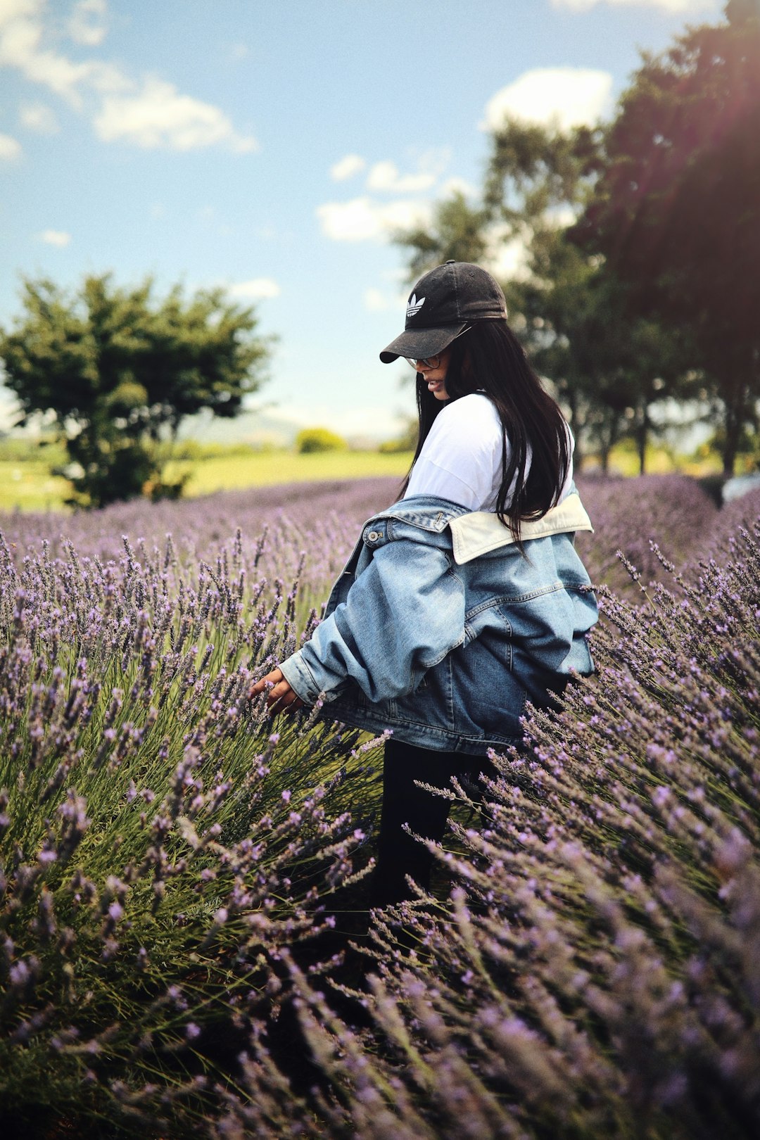 woman standing on purple flower field during daytime