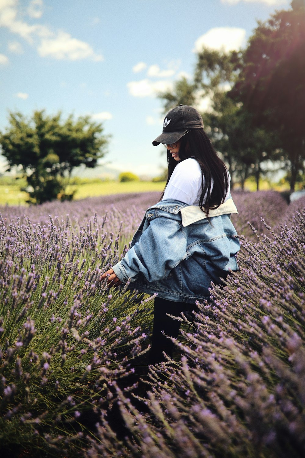 woman standing on purple flower field during daytime