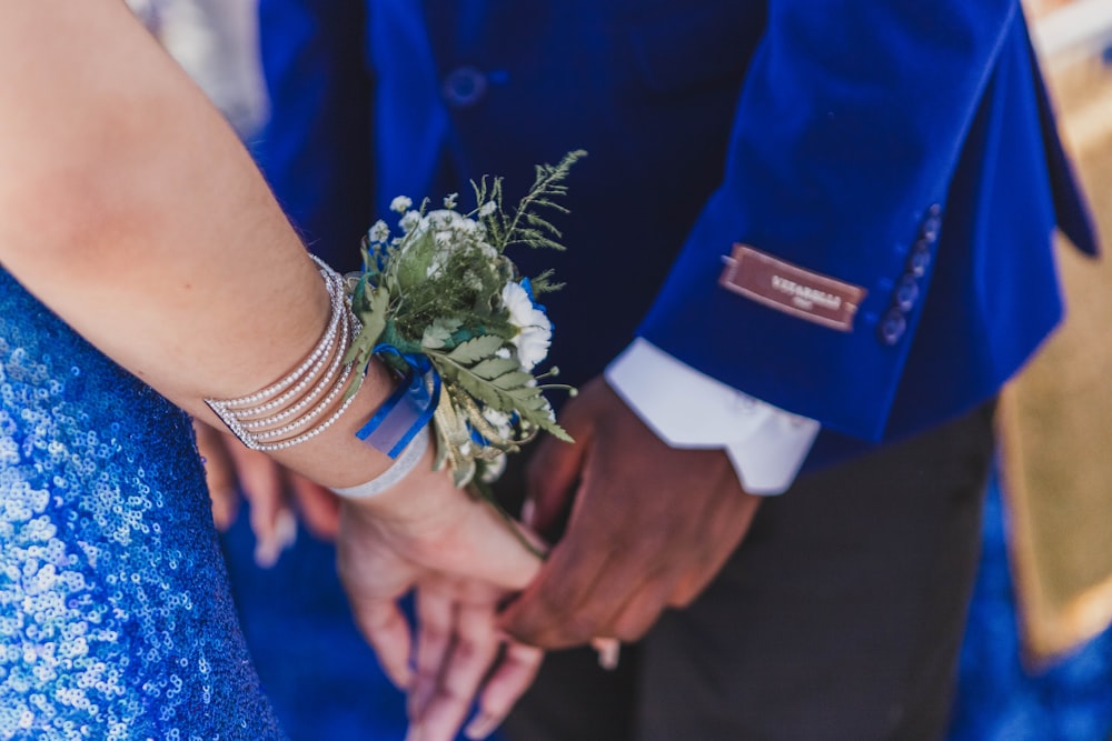 man and woman standing and holding hands