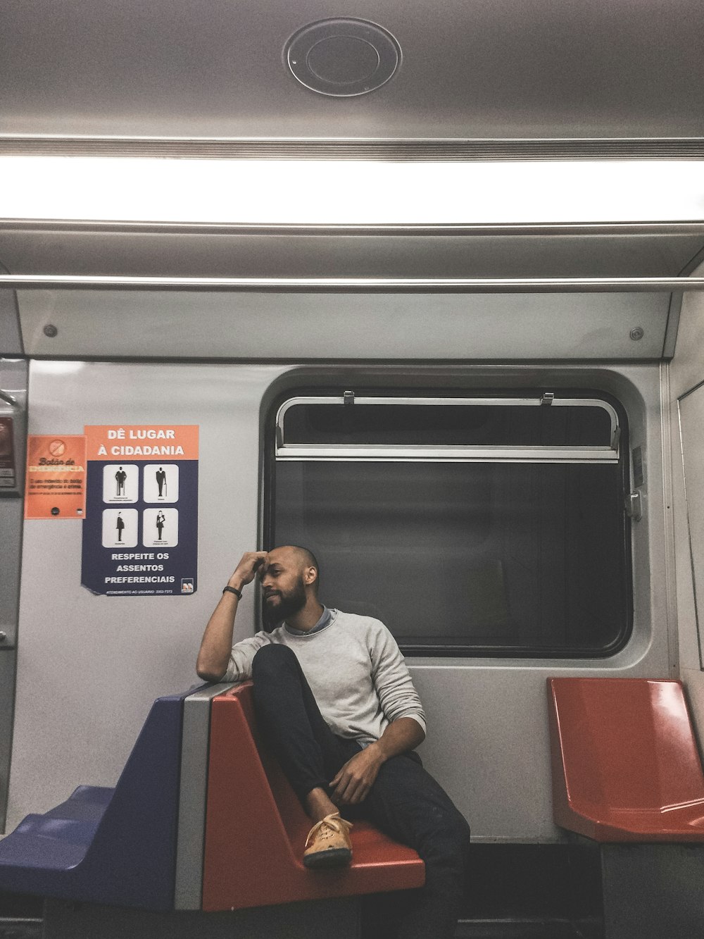 man sitting on train chair