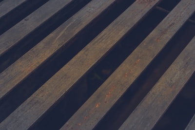 Rows of parallel steel bars with a weathered, rusty surface running diagonally across the image.