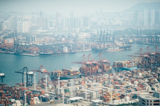 aerial photo of concrete buildings near body of water during daytime