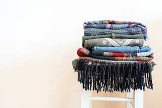 Stacks of colorful textiles neatly arranged, highlighting texture and fabric variety.
