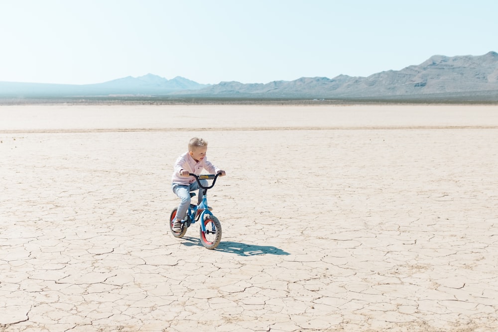 toddler riding bike on dry soil