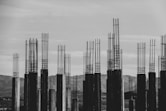 grayscale photography of concrete posts