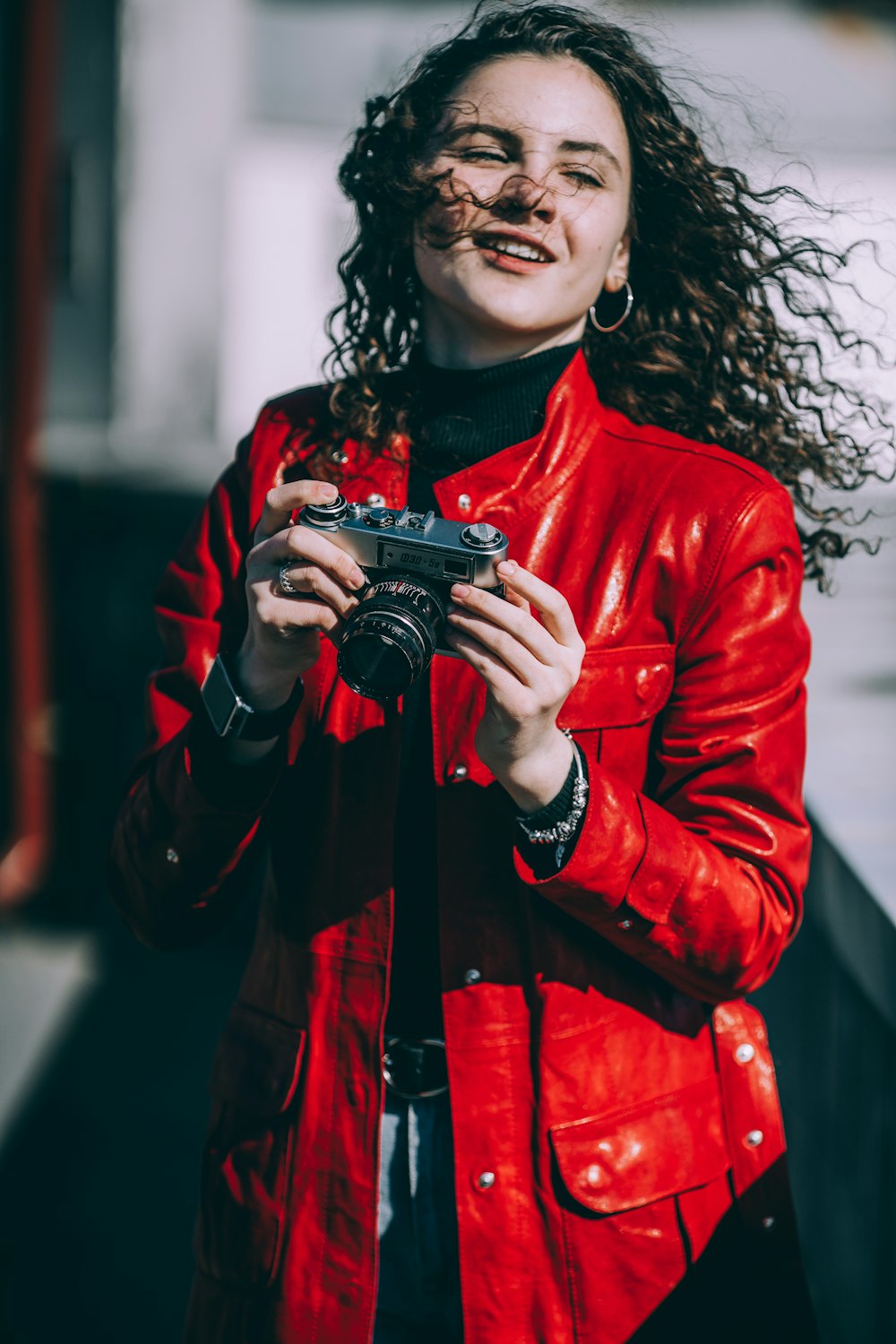 woman holding gray camera