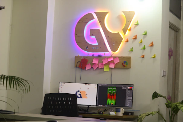 A modern workspace featuring a variety of printed banners and posters in blue and purple hues
