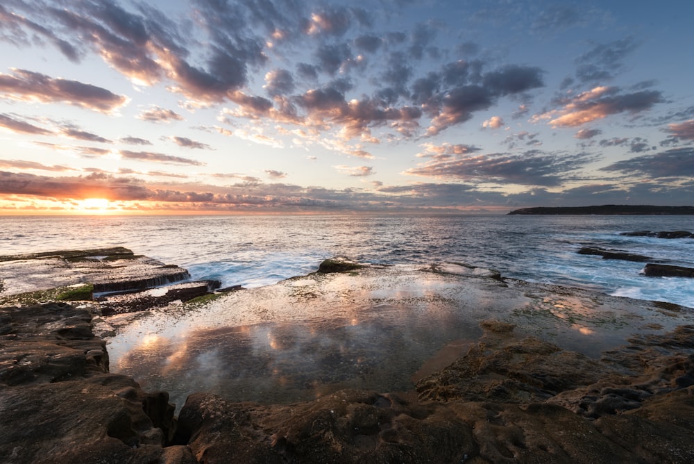 calm body of water during golden hour