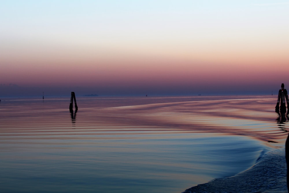 wavy body of water during golden hour