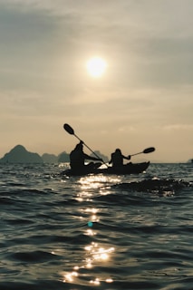silhouette photo of person riding on boat