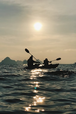 silhouette photo of person riding on boat