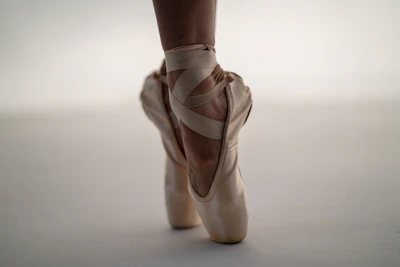 person in white ballet shoes
