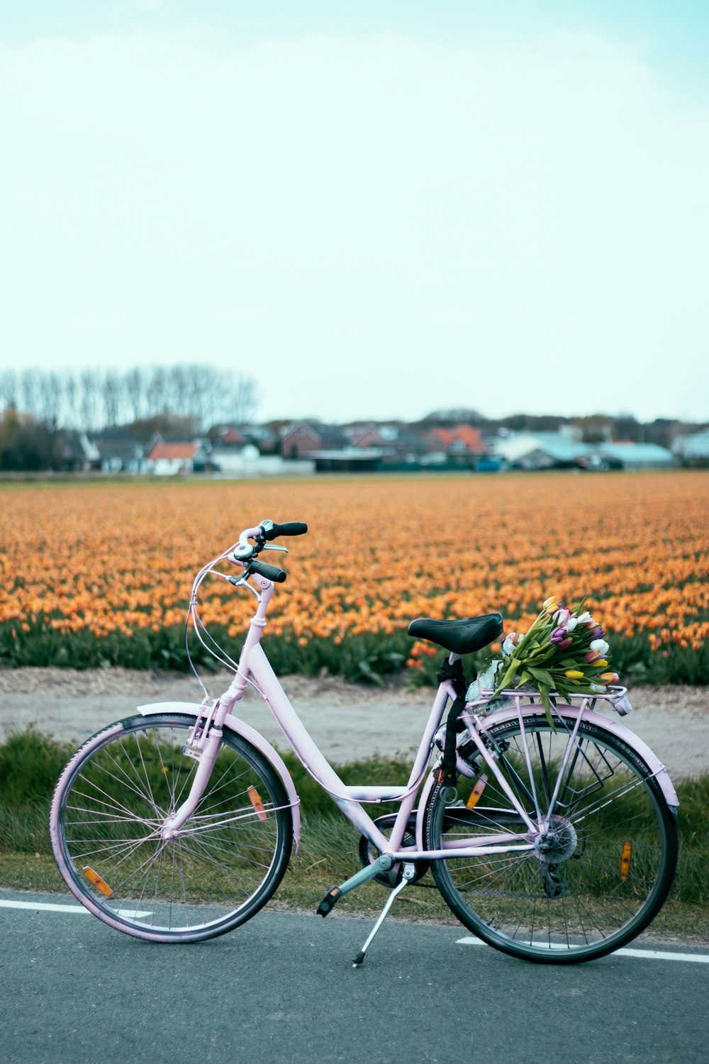 white bicycle parked on road