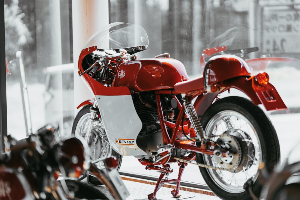 red and white motorcycle in room