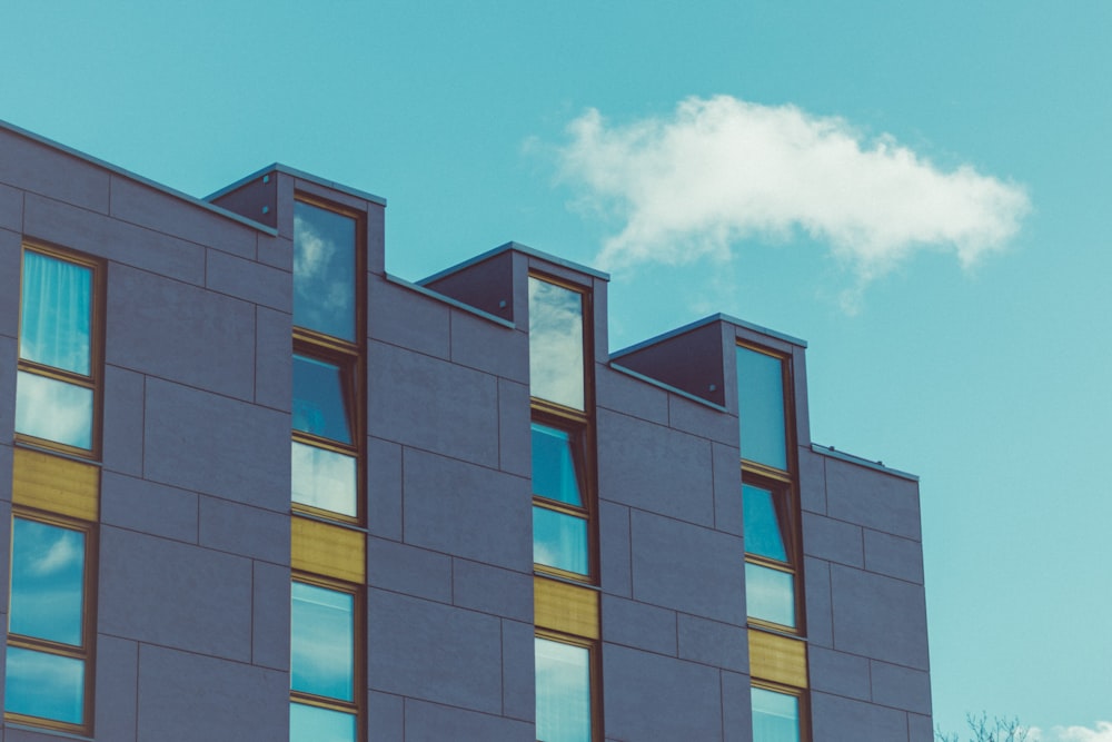 a tall building with many windows and a sky background