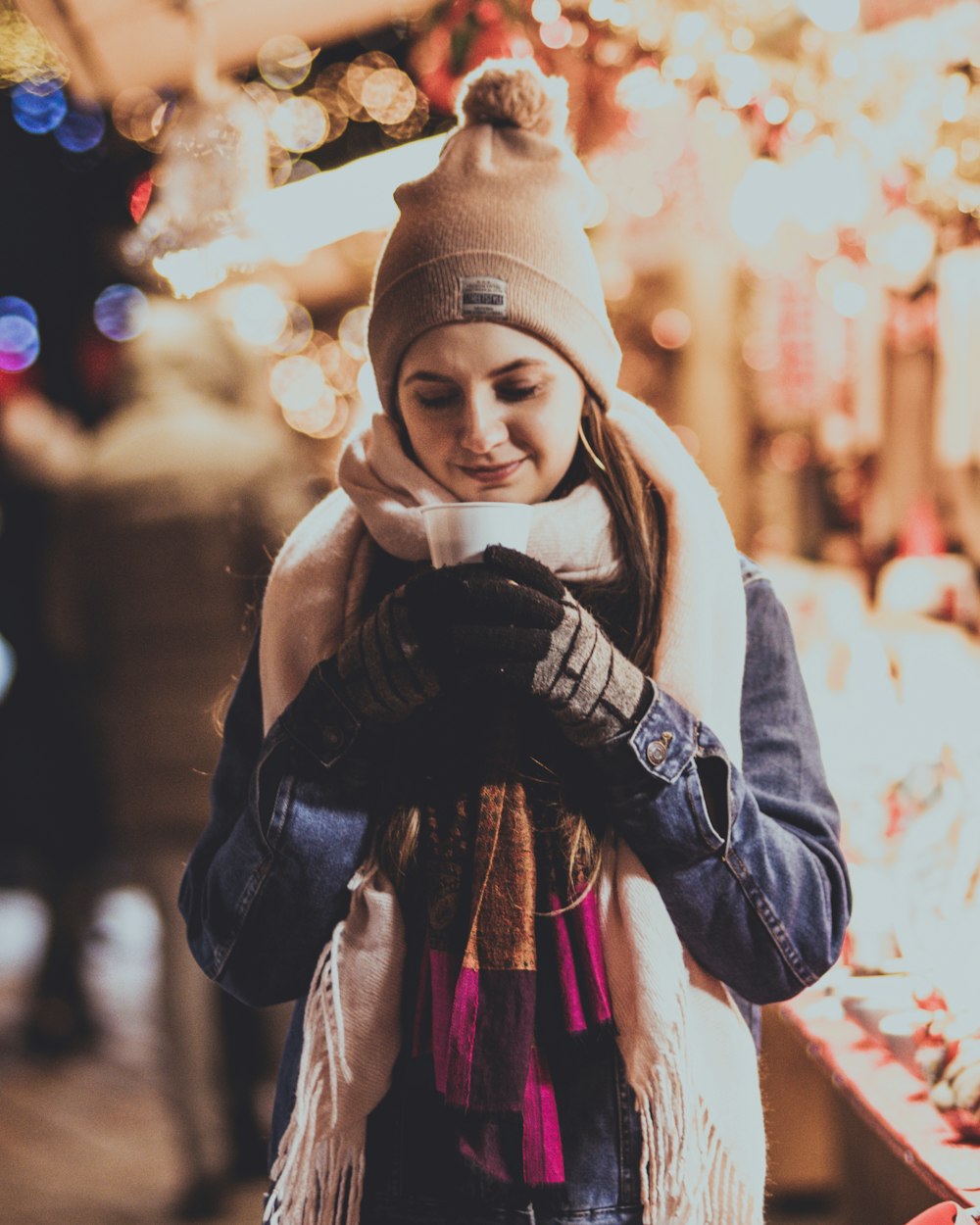 woman holding cup at night