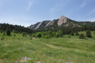 A scenic view of a mountain landscape with travelers enjoying the outdoors.