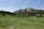 A scenic view of a mountain range with travelers enjoying the landscape.