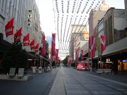 A friendly Melbourne street scene with a small business storefront and digital marketing icons floating above.