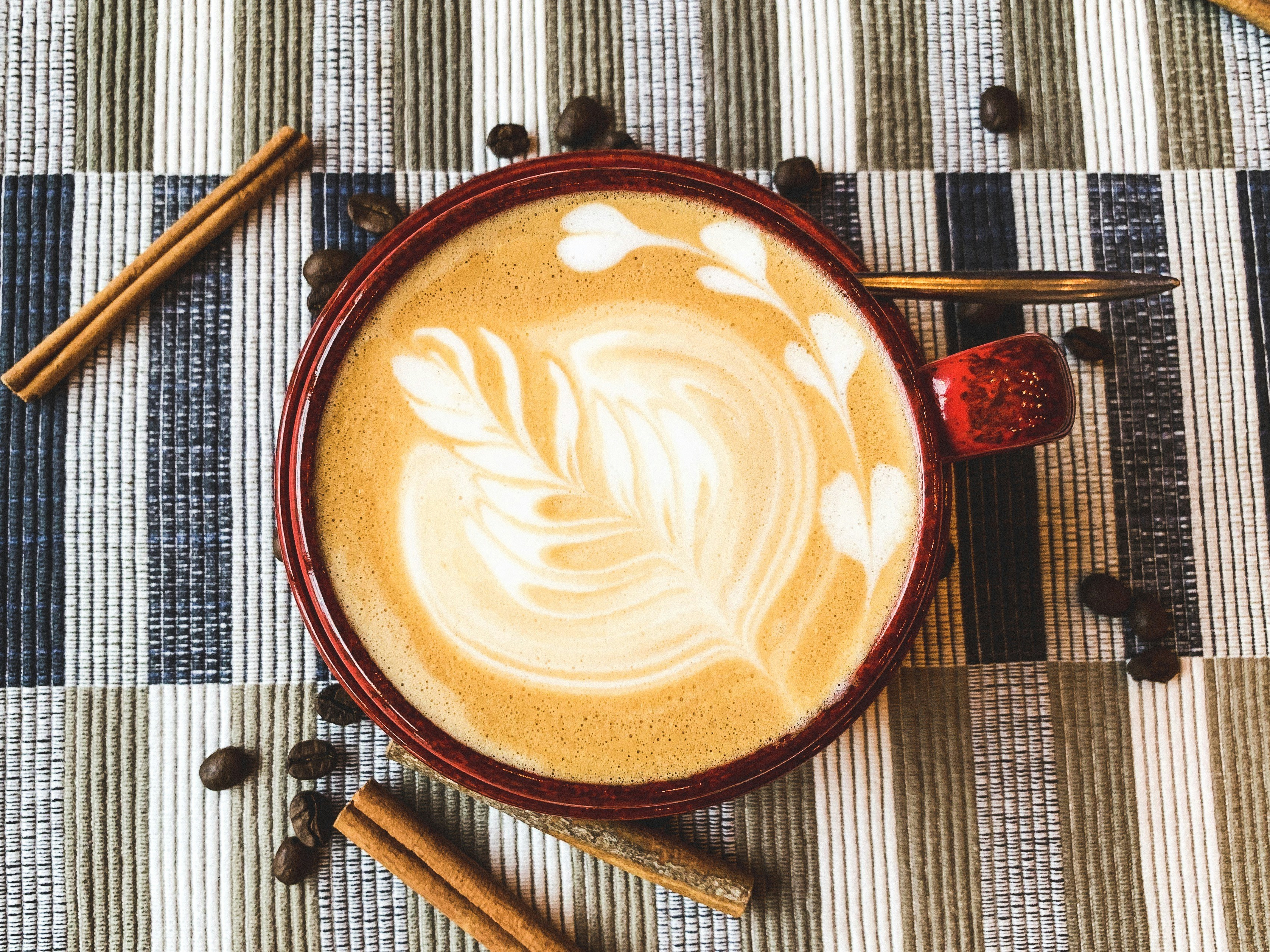 flat lay photography of coffee latte with art