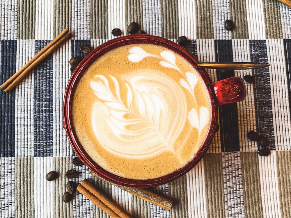 flat lay photography of coffee latte with art