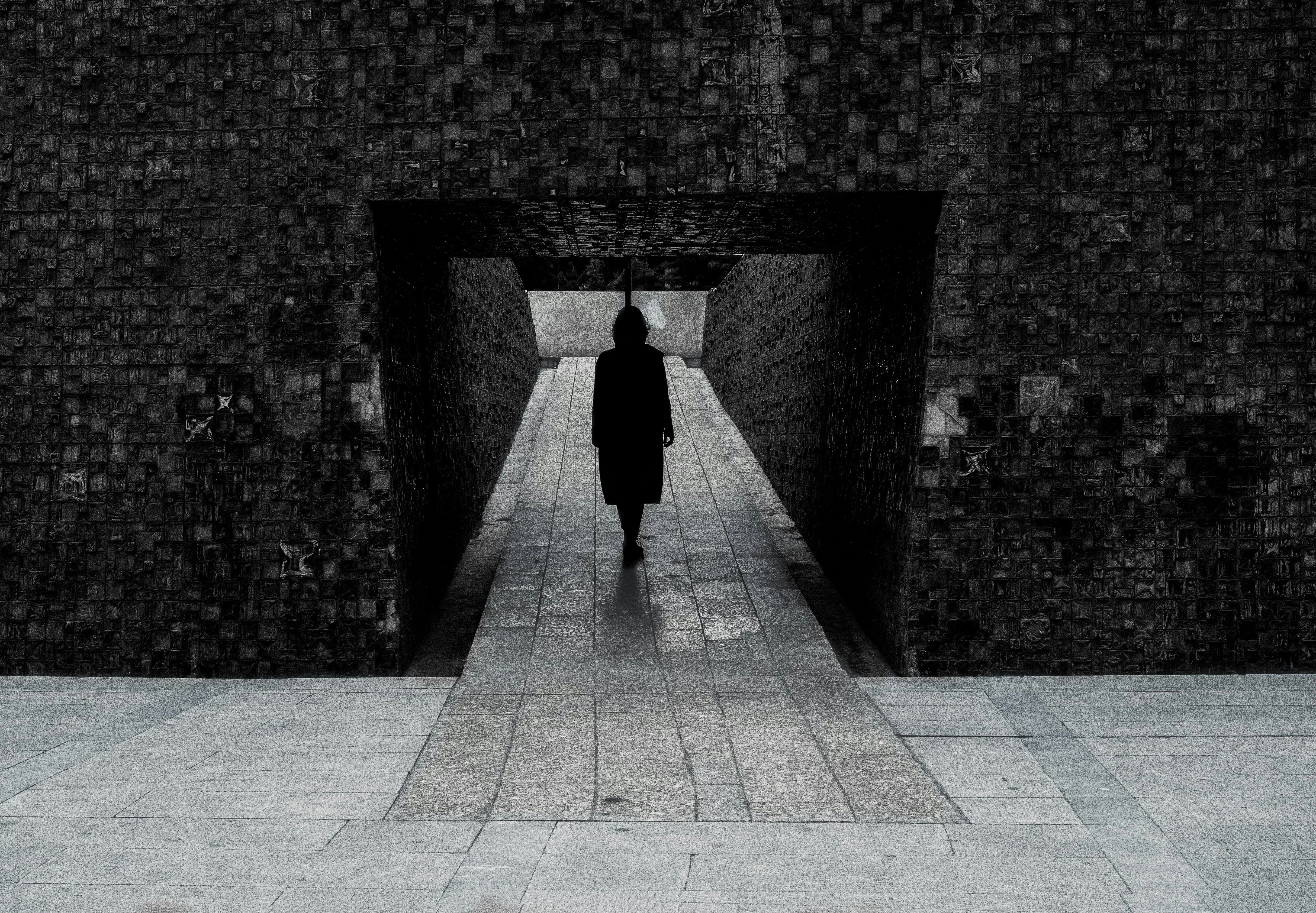 woman standing on a concrete hallway