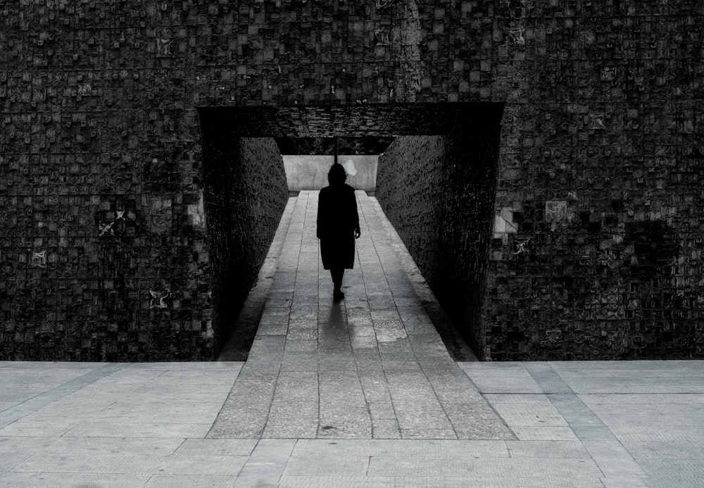 woman standing on a concrete hallway
