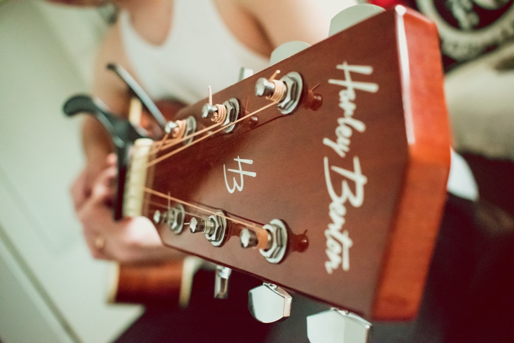 a person holding a guitar with a happy birthday message on it