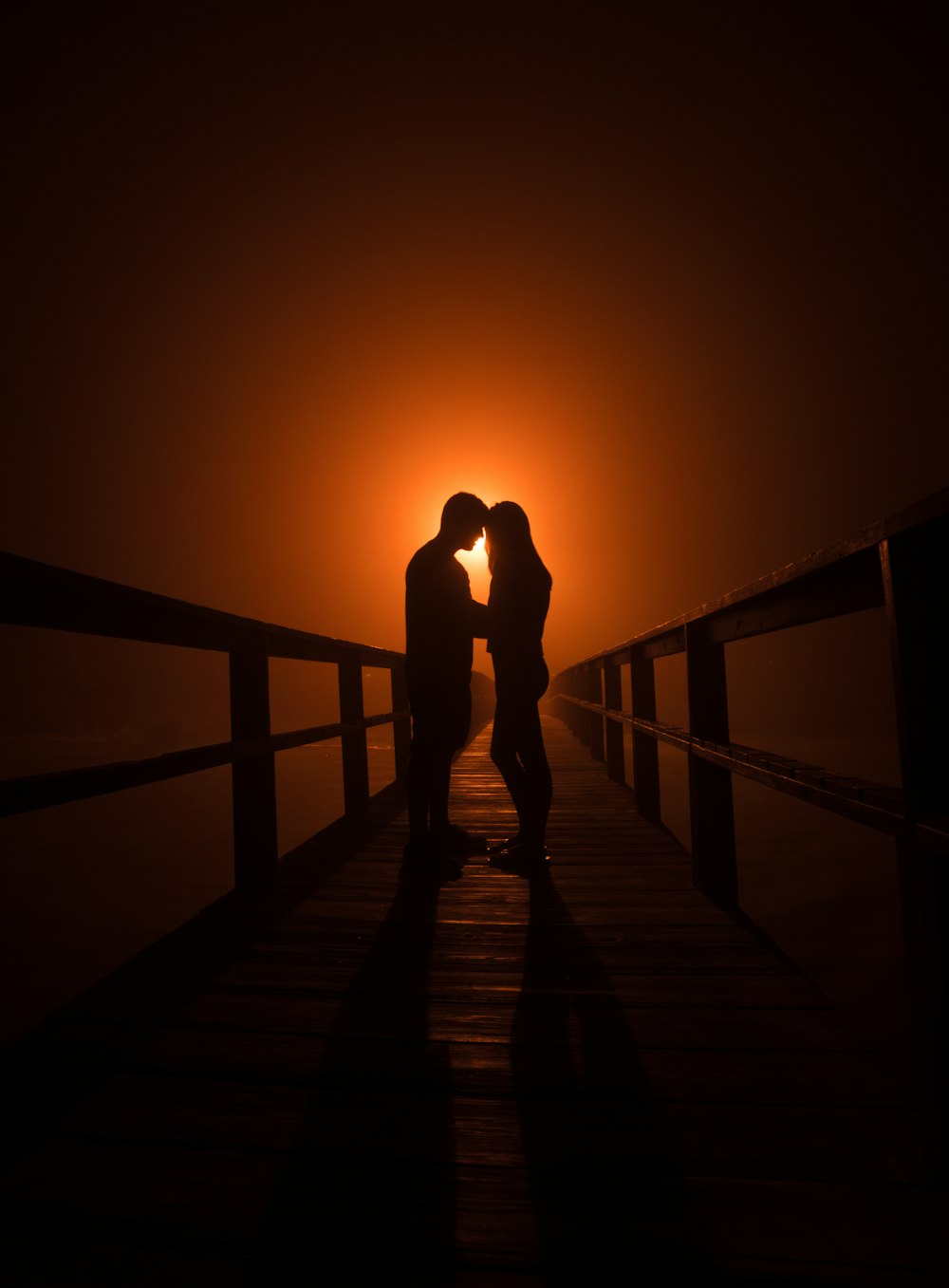 man and woman standing on wooden dock