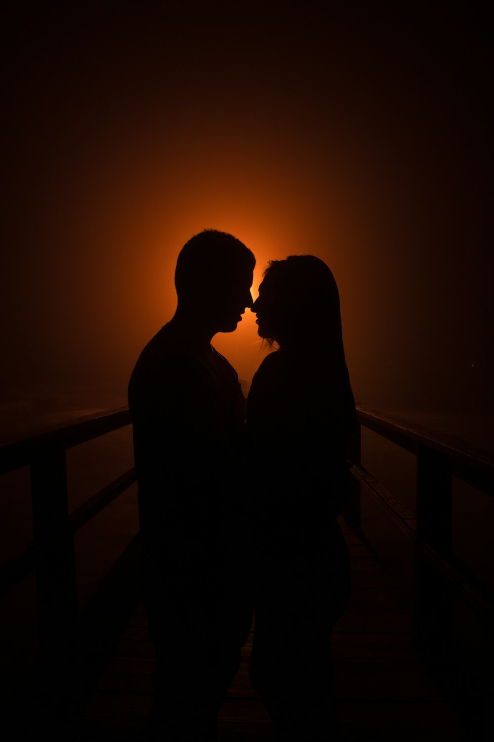 a man and a woman kissing in the dark