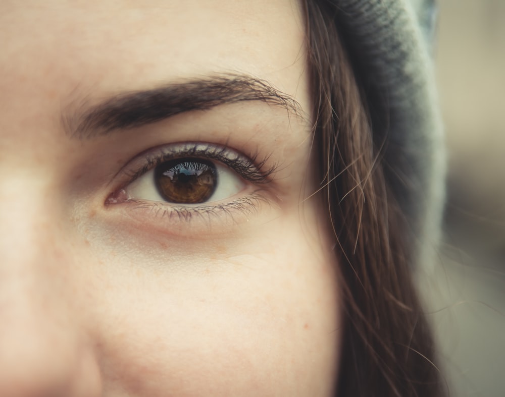 a close up of a woman's brown eyes