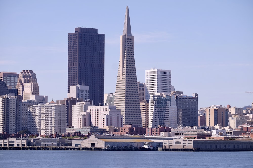 beige concrete buildings near body of water