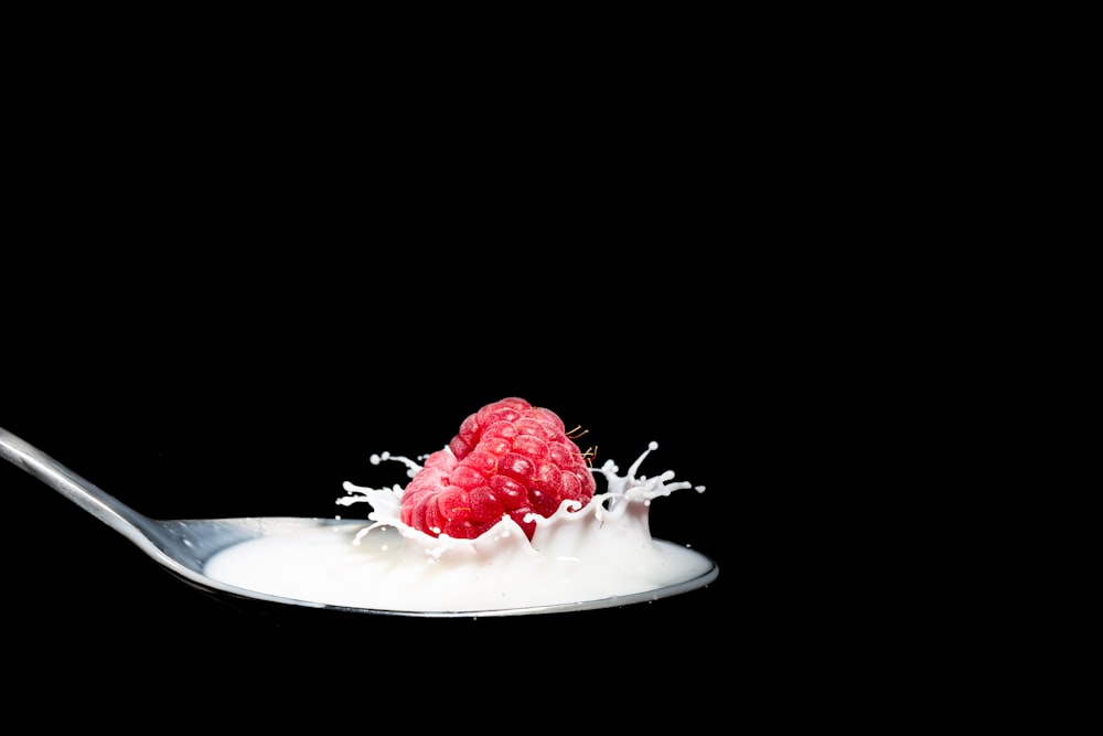 strawberry fruit with milk on spoon