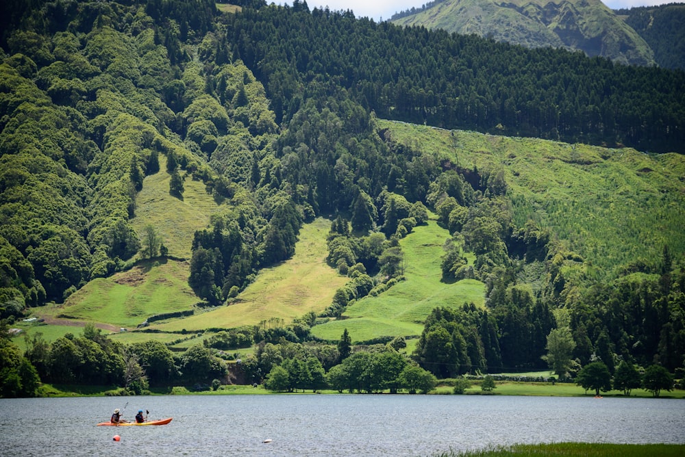 two person sailing on boat near island