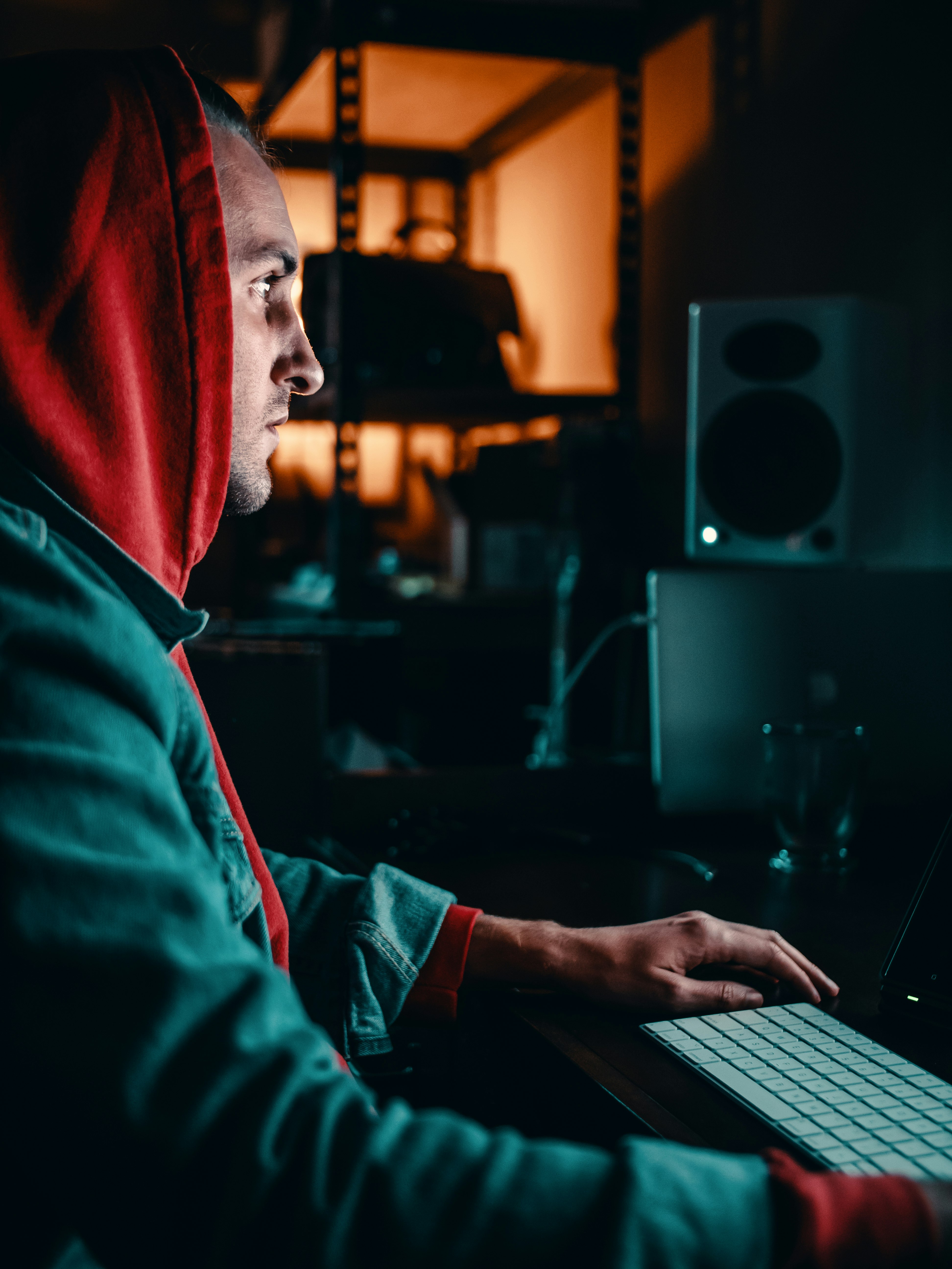 man wearing hoodie using computer