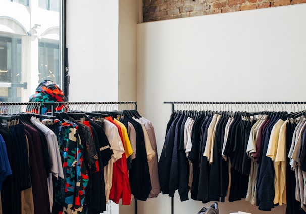 assorted-color clothes hanging on metal racks