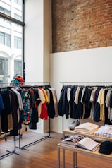 assorted-color clothes hanging on metal racks
